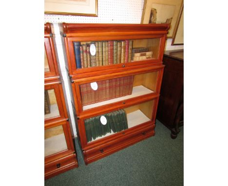 Three-tier glazed sectional bookcase with single drawer to base in stained light wood, probably second quarter 20th century, 