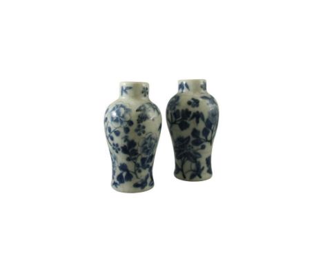of baluster form the vases decorated in underglazed blue with flora and fauna designs, bearing four character Kangxi mark to 