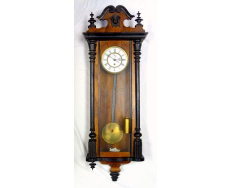 Viennese regulator wall clock, walnut and ebony case with mask decoration, enamel dial with Roman numerals, pendulum and sing