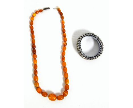 An amber bead necklace 17.2 grams, others, cherry red bakelite type beads 44 grams, and mother of pearl leaves, paste set exp