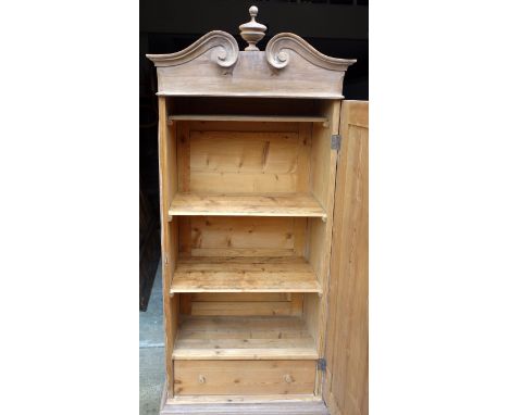 19th century Hungarian pine cupboard with split pediment and turned finial, above door enclosing three shelves and a drawer H