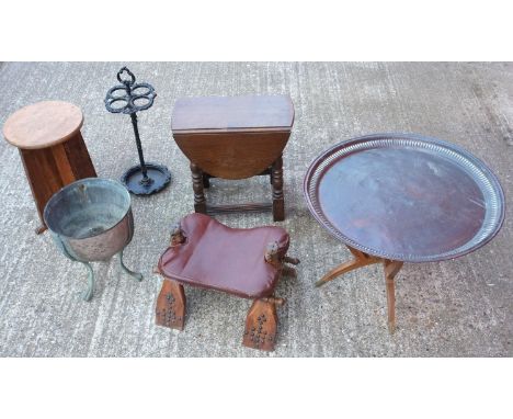 Eastern brass tray on stand, a 'camel' seat,  a cast iron stick stand, small oak drop flap table and a brass and copper baske