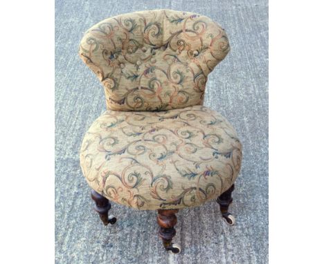 Victorian nursing chair upholstered in tapestry style fabric, on shaped mahogany legs with castors