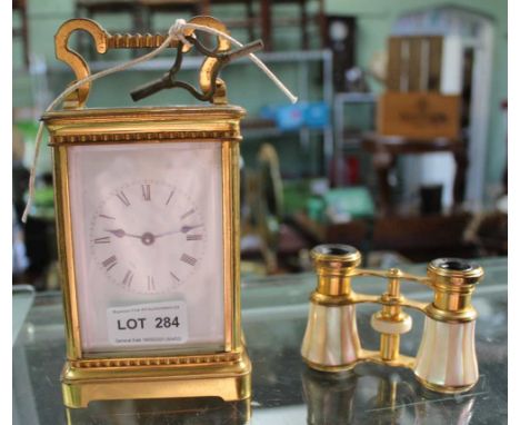 A PAIR OF FRENCH MADE MOTHER-OF-PEARL MOUNTED OPERA GLASSES, together with a large brass &amp; glass traditional carriage tim