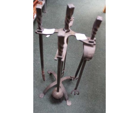 A WROUGHT IRON COMPANION STAND containing three matching utensils plus an extra toasting fork 
