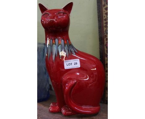 A ROUGE GLAZED POOLE POTTERY SEATED CAT 