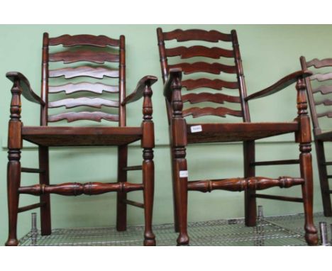 A HARLEQUIN SET OF RUSH SEATED LADDER BACK CHAIRS comprising six singles and two carvers 
