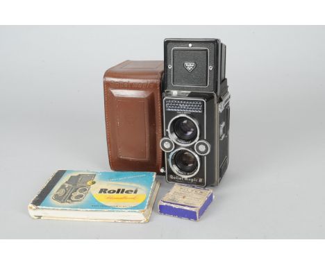 A Rollei Magic II TLR Camera, shutter firing, body G, elements F-G, fungus, in case, with Rollei handbook and Rolleiflex guid
