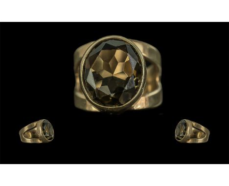 A Fine 9ct Gold Single Stone Smoky Topaz Set Ring. Full Hallmark to Shank. The Oval Shaped Faceted Topaz of Excellent Colour 