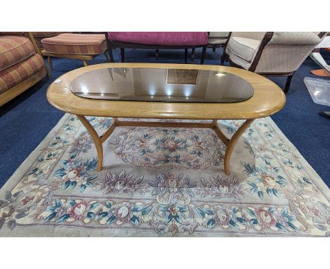 Ercol Blonde Coffee Table, oval shape, turned supports, measures 19'' height x 45'' length x 23'' depth.