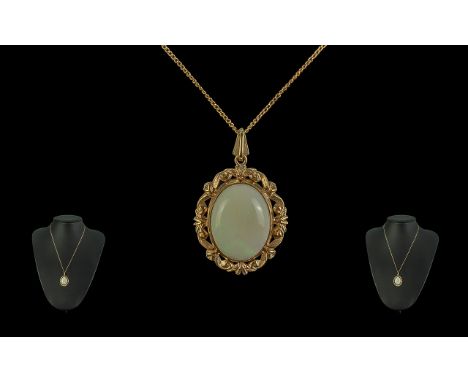 Ladies Attractive 9ct Gold Opal Set Pendant with attached 9ct gold chain the large oval shaped opal of subtle colours est opa