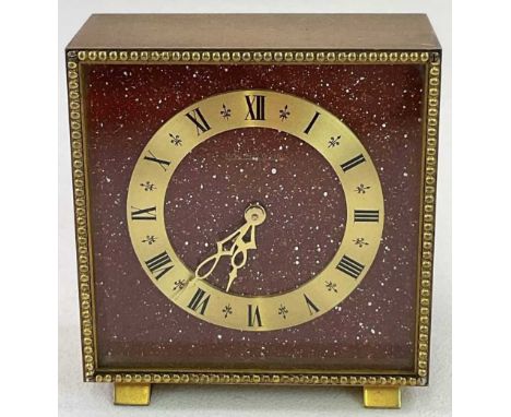 JAEGER LECOULTRE; a brushed brass desk clock with Roman numerals to the chapter ring spaced with fleur-de-lys, painted signed
