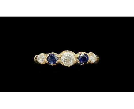 A yellow metal sapphire and diamond five stone graduated ring, the central diamond weighing approx 0.15ct, size O, approx 2.4