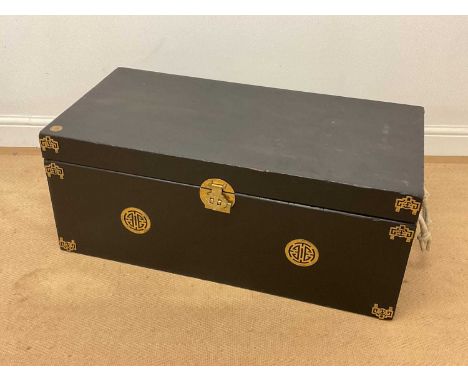 A Chinese black painted wooden trunk with rope handles and brass lock and pierced plates, height 38cm, width 92cm, depth 46cm