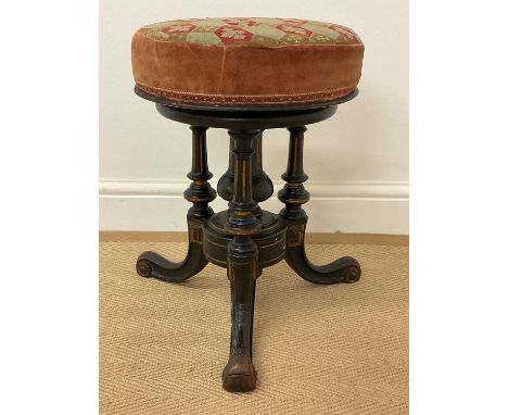An ebonised Aesthetic Movement adjustable piano stool with tapestry seat, height 46cm.