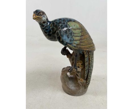 A large Chinese pottery model of an exotic bird set on a rocky outcrop, height 40cm.