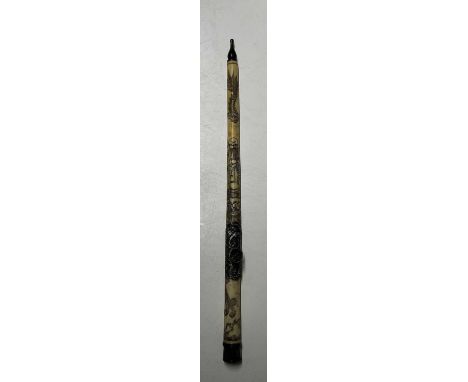 A Chinese bone opium pipe, 47cm, decorated with an Oriental figure and a pair of fish.