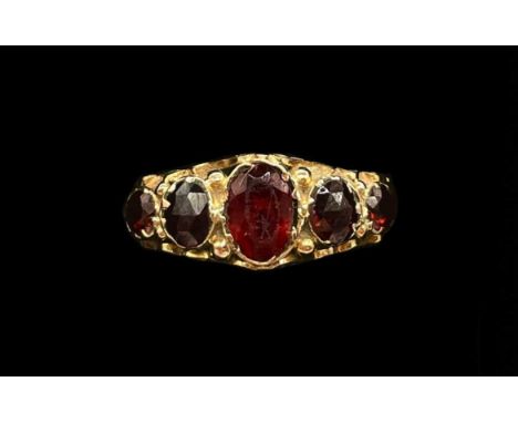 A 9ct rose gold and five stone graduated garnet set ring, size M, approx 1.8g.