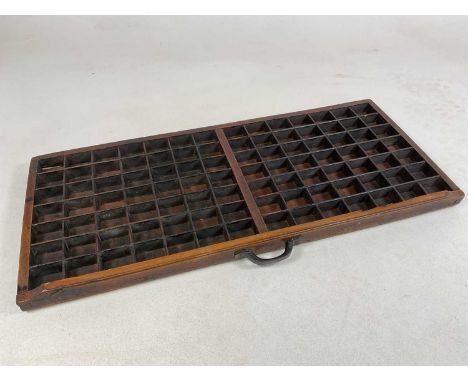 A vintage multi-sectioned printing block tray, 83.5 x 36.5cm.