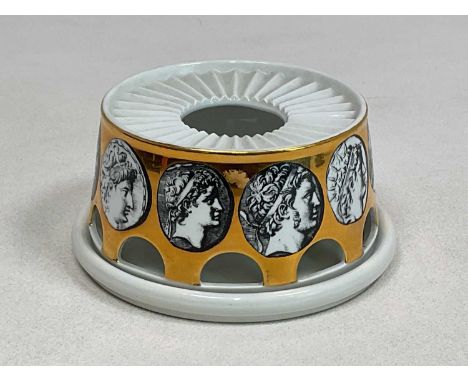 FORNASETTI; a teapot warmer and stand, decorated with oval portrait medallions to the gilt heightened body, printed marks to 