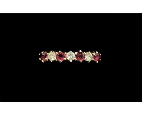 An 18ct yellow gold ruby and diamond seven stone ring, the three round brilliant cut diamonds, each weighing approx 0.05ct, s