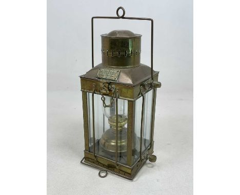 A reproduction brass oil lamp, bearing plaque 'CARGO LIGHT No 3394 GREAT BRITAIN 1939', height 38cm.