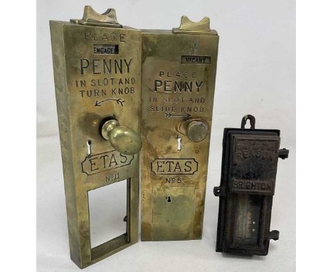 A pair of penny in the slot brass toilet door locks with a vintage electric meter, together with all the pieces to repair the