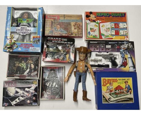 A quantity of modern and vintage toys, to include a boxed Thinkway Buzz Lightyear, an unboxed Woody, two Hasbro transformers 