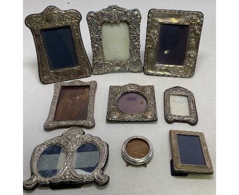 A group of nine silver fronted photograph frames of various sizes, some af, some with velvet easel backs. indistinct hallmark