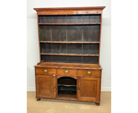 An oak dresser, the dog kennel base with shelf and three drawers above cupboard doors, and three shelf back, height 215cm, wi