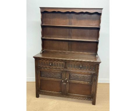 An oak dresser, the base with two drawers above cupboard doors and three shelf back, height 175cm, width 122cm, depth 43cm.