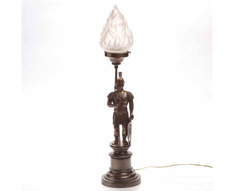 VICTORIAN BRONZED SPELTER TABLE LAMP
in the form of a Roman soldier, with spear and shield, frosted glass flaming torch shade