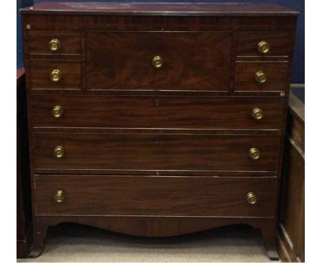 REGENCY MAHOGANY OBLONG SECRETAIRE CHEST OF DRAWERS 
the central secretaire drawer enclosing a fitted interior, flanked by tw