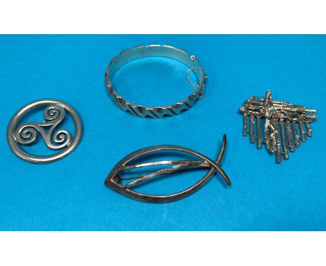 Three modernist white metal brooches in the style of Georg Jensen; a Mexican silver bangle 