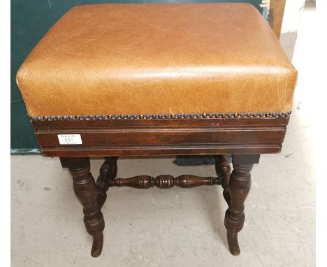 An Edwardian mahogany piano stool, rise and fall action, on turned legs, cushion seat 