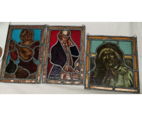 Three leaded and coloured glass panels depicting a Jester, a drunk and a man in top hat; a 1930's spatter glass light bowl an