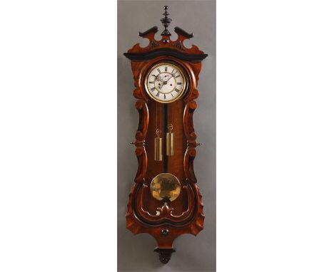 A good late 19th Century Walnut and ebonized Vienna style WALL CLOCK the shaped long door and brass edged cream enamelled dia