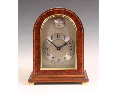 A 20th Century inlaid Amboyna arch-top MANTEL CLOCK on brass bun feet with silvered dial, Arabic chapter ring and Swiss sprin