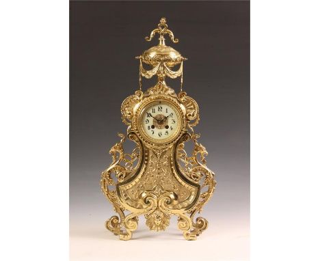 An ornate late 19th Century French large Cast Brass MANTEL CLOCK with draping urn surmount above griffin side pieces and a de