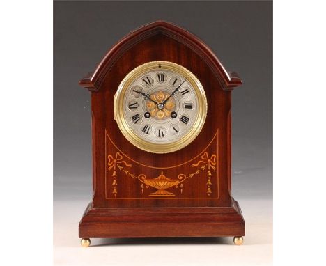 An Edwardian marquetry inlaid Mahogany lancet-top MANTEL CLOCK with brass and silvered concave dial, Roman chapter ring and g