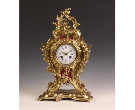 A good 19th Century French rococo ornate Cast Brass MANTEL CLOCK of leaf work design.&nbsp; The enamelled convex dial with bl