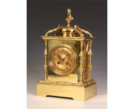 A stylish late 19th Century French Cast Brass MANTEL CLOCK with flattened bun pediment and female bust finial supported by le