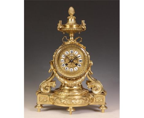 A stylish late 19th Century French Cast Brass MANTEL CLOCK with bowed leaf cast base, scrolled sides and adjoining swag with 