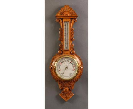 A late 19th Century honey coloured leaf carved Oak ANEROID BAROMETER with painted porcelain dials 87cms high