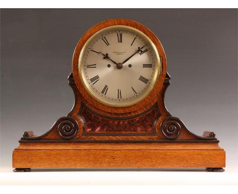 MAPLE &amp; Co Ltd.An impressive late 19th Century ebonized and honey coloured Oak Boardroom style BRACKET CLOCK with scrolle