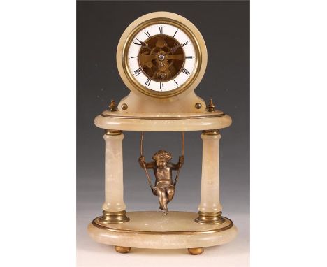 A 19th Century French Alabaster and brass mounted oval MANTEL CLOCK of small size with twin columns supporting a raised platf