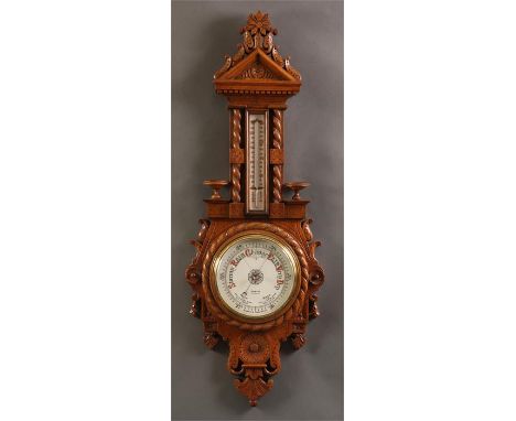 STEWARD, LEICESTERA fine late 19th Century elaborately carved Oak ANEROID BAROMETER/THERMOMETER with 8&rdquo; signed porcelai