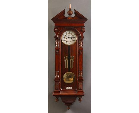 A good late 19th Century Walnut Vienna style WALL CLOCK with architectural pediment, squared and half turned tapering side co