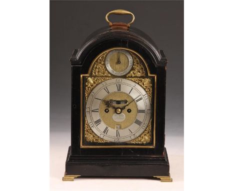 THOMAS MUDGE, LONDONGeorge III ebonized arched top BRACKET CLOCK with brass folding handle and ogee feet, the 7" arched brass