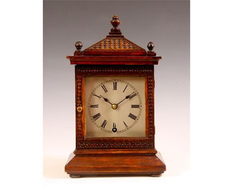A late 19th Century carved Oak MANTEL CLOCK with sloping pediment and silvered sheet brass Roman dial fronting an eight day W